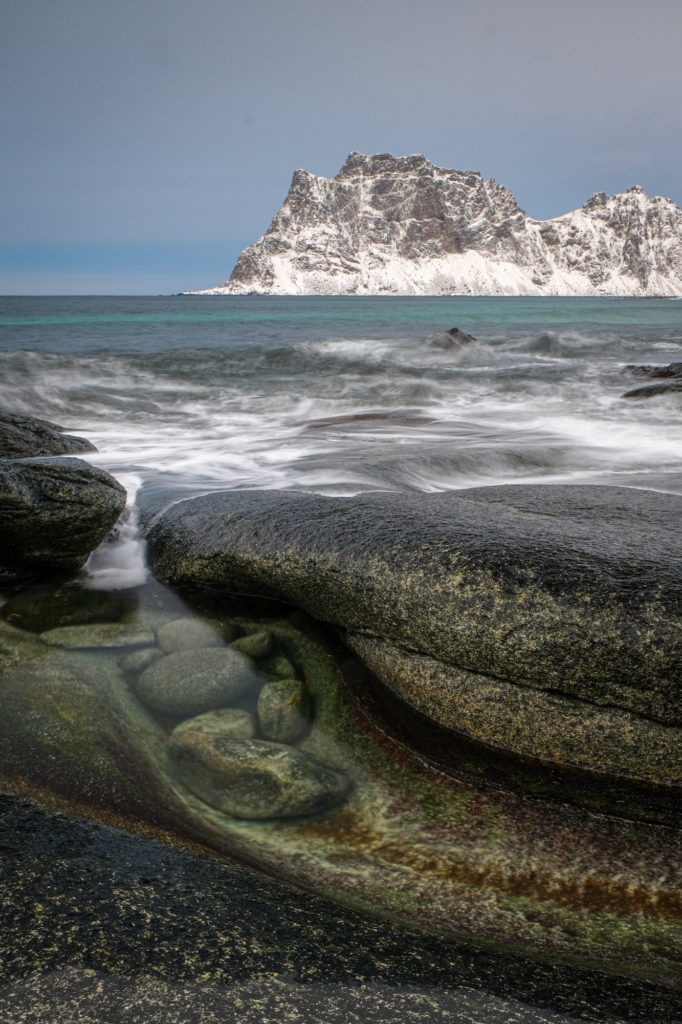 Snowy mountains surf ocean Norway