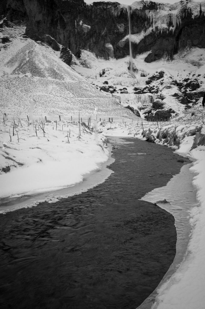Waterfall and ice with creek in Iceland
