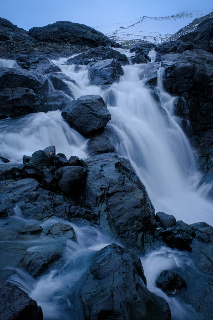 Glacier waterfall from mountains in Iceland