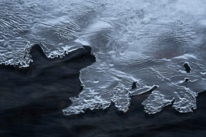 Ice builds up alongside a stream in Iceland